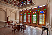 Interior view of a room with stained-glass windows in Qavam House (Narenjestan-e Ghavam), 19th century historic house. Shiraz, Iran.