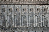 Bas-relief on the Grand Staircase of Apadana Palace depicts members of the Ten Thousand Immortals, special army of ancient Persia. Persepolis, Iran.