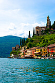 House and Church on Mountain Range in a Sunny Summer Day on the Waterfront to Lake Lugano in Morcote, Lugano, Ticino, Switzerland.