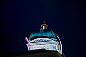 Beautiful Tower of the Bundeshaus Illuminated Parliament Building or Federal Palace with Flag at Night in City of Bern, Bern Canton, Switzerland.