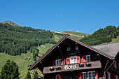 Hotel and Ski Lift on the Mountain with Blue Clear Sky in a Sunny Summer Day in Andermatt, Uri, Switzerland.