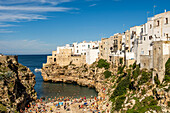 View on Cala Monachile or Lama Monachile from the Roman bridge behind the bay Polignano a Mare, Puglia, Italy.