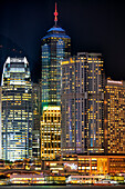 Modern high-rise buildings at Central Waterfront illuminated at night. Hong Kong, China.