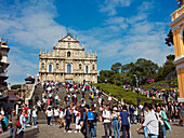 Crowd of tourists at the Ruins of Saint Paul's, a 17th-century Catholic religious complex, now one of Macau's best known landmarks. Macau, China.