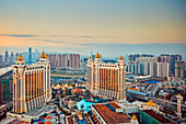 Aerial view of the Galaxy Macau Hotel, a luxurious resort complex, at dusk. Cotai, Macau, China.