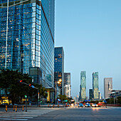 High-rise buildings in Futian Central Business District (CBD) illuminated at dusk. Shenzhen, Guangdong Province, China.