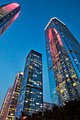 High-rise buildings in Futian Central Business District (CBD) illuminated at dusk. Shenzhen, Guangdong Province, China.