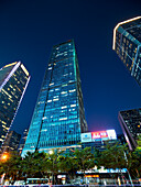 High-rise buildings in Futian Central Business District (CBD) illuminated at dusk. Shenzhen, Guangdong Province, China.