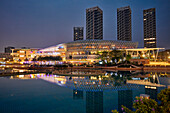 Buildings at the Sea World Plaza illuminated at dusk. Shekou, Shenzhen, Guangdong Province, China.