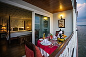  The private dining table is on the balcony of the deluxe cabin on board the boutique river cruise ship The Jahan (Heritage Line) on the Mekong River, near Cao Lanh, Dong Thap, Vietnam, Asia 