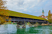 Old Town and the Historical Covered Wood Bridge Holzbrücke over River Aare in a Sunny Day with Clouds in Olten, Canton Solothurn, Switzerland.