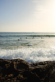  Surfers in the waves of Taghazout near the surf spot &quot;Anker Point&quot;. 