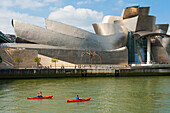 kayak on the Nervion River in front of the Guggenheim Museum designed by architect Frank Gehry, Bilbao, province of Biscay, Basque Country, Spain,Europe