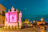 Der farbig beleuchtete Griechische Brunnen Fontana Greca in der Abenddämmerung, Gallipoli, Apulien, Italien, Europa