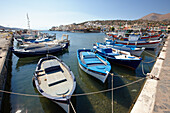 Traditional fishing boats moored in Elounda village harbour. Crete, Greece.