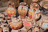 A selection of replicas of ancient Greek pottery displayed at an outdoor pottery market. Crete, Greece.