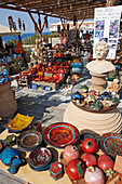 A selection of various handmade ceramic items displayed for sale at an outdoor market. Crete, Greece.