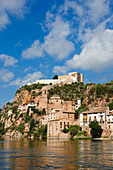 View of Miravet village with Miravet Castle on top of the hill. Miravet, Catalonia, Spain.