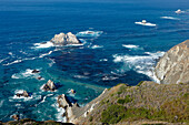 Sea waves breaking on rocks at Big Sur coast. California, USA.