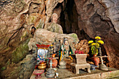 Seated Buddha statue in Tang Chon Cave. Thuy Son Mountain, The Marble Mountains, Da Nang, Vietnam.