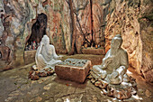 Two wise men play Xiangqi (Chinese chess) – sculpture in Ban Co (Chess Board) Grotto in the Tang Chon Cave. The Marble Mountains, Da Nang, Vietnam.