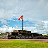 Vietnam national flag flying in the wind on top of the Flagtower of Imperial City. Hue, Vietnam.