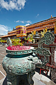 Large bronze urn with incense sticks at The To Mieu Temple. Imperial City (The Citadel), Hue, Vietnam.