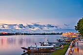 Dragon boats moored at the bank of Perfume River at dusk. Hue, Vietnam.