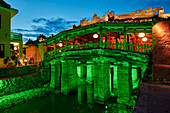 Exterior view of the Japanese Covered Bridge illuminated at dusk. Hoi An Ancient Town, Quang Nam Province, Vietnam.