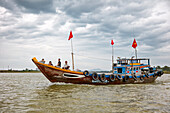 Traditional boat moving on the Thu Bon River. Hoi An, Quang Nam Province, Vietnam.