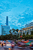 Cars move in Nguyen Hue street at dusk. District 1, Ho Chi Minh City, Vietnam.