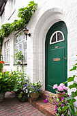  House entrance with flower pot at historic house 