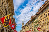 Beautiful Old City Street with Old Building and Flags in a Sunny Summer Day in City of Bern, Canton Bern, Switzerland.