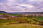  View over a vast autumn landscape with hills, a village and dramatic cloudy sky, Kunitz, Thuringia, Germany 