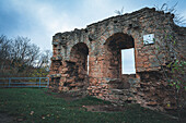  Brick ruin of Kunitzburg with several arches, surrounded by autumnal nature and cloudy sky, Kunitz, Thuringia, Germany 