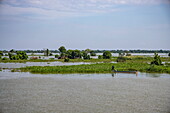  Fisherman in a canoe on Tonle Sap Lake, Tonle Sap Lake, Cambodia, Asia 