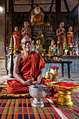  Buddhist monk celebrates blessing ceremony at Wat Kampong Tralach Leu temple, Kampong Tralach, Kampong Tralach district, Kampong Chhnang, Cambodia, Asia 