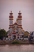  Cao Dai Temple on the Mekong River at sunset, Tan Chau, An Giang, Vietnam, Asia 