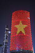  Vietnamese national flag with yellow star on red background shines on a skyscraper under construction (has been lying idle as a ruin since 2013), Ho Chi Minh City, Vietnam, Asia 