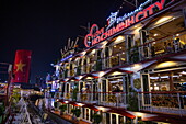  The illuminated dinner cruise boat Indochine approaches the pier on the Saigon River at night, Ho Chi Minh City, Vietnam, Asia 