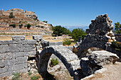 Ruins of a market hall with the Acropolis Hill visible in the background. Tlos, an ancient Lycian city in the South West of modern Turkey.