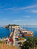 Boats moored at pier near the Castle on Pigeon Island. Kusadasi, Aydin Province, Turkey.