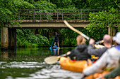  SUP, stand up paddlers and kayakers tourists travel on the Spreewald stream, kayak, water hiking, water hikers, excursion, local recreation area, UNESCO biosphere reserve, Spreewald, local recreation area, Brandenburg, Germany\n 