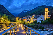  Bridge leading to illuminated mountain village of Rosazza, GTA, Grande Traversée des Alpes, Biella, Alpi Biellesi, Valais Alps, Piedmont, Italy 