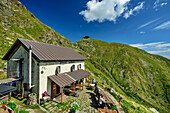  Several people sitting in front of the Rifugio Rosazza hut, Monte Camino, GTA, Grande Traversée des Alpes, Biella, Alpi Biellesi, Valais Alps, Piedmont, Italy 