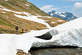 trekkers along the Reno di Medels river,Val Piora,Canton Ticino,Switzerland,Europe