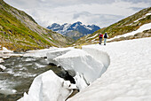 trekkers along the Reno di Medels river,Val Piora,Canton Ticino,Switzerland,Europe