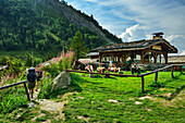  Several people taking a break in the garden in front of the Refuge du Miage, Tour du Mont Blanc, Mont Blanc Group, Graian Alps, Haute-Savoie, Upper Savoy, France 