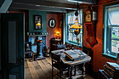 A vintage room with antique furniture, including a grandfather clock, wooden table with books, and a fireplace. The room is dimly lit with old-fashioned lamps and has a cozy, nostalgic atmosphere.