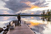  Man on the jetty at Lake Isteren, Björnberga, Innlandet, Norway 